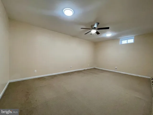 an empty room with a ceiling fan and a ceiling fan