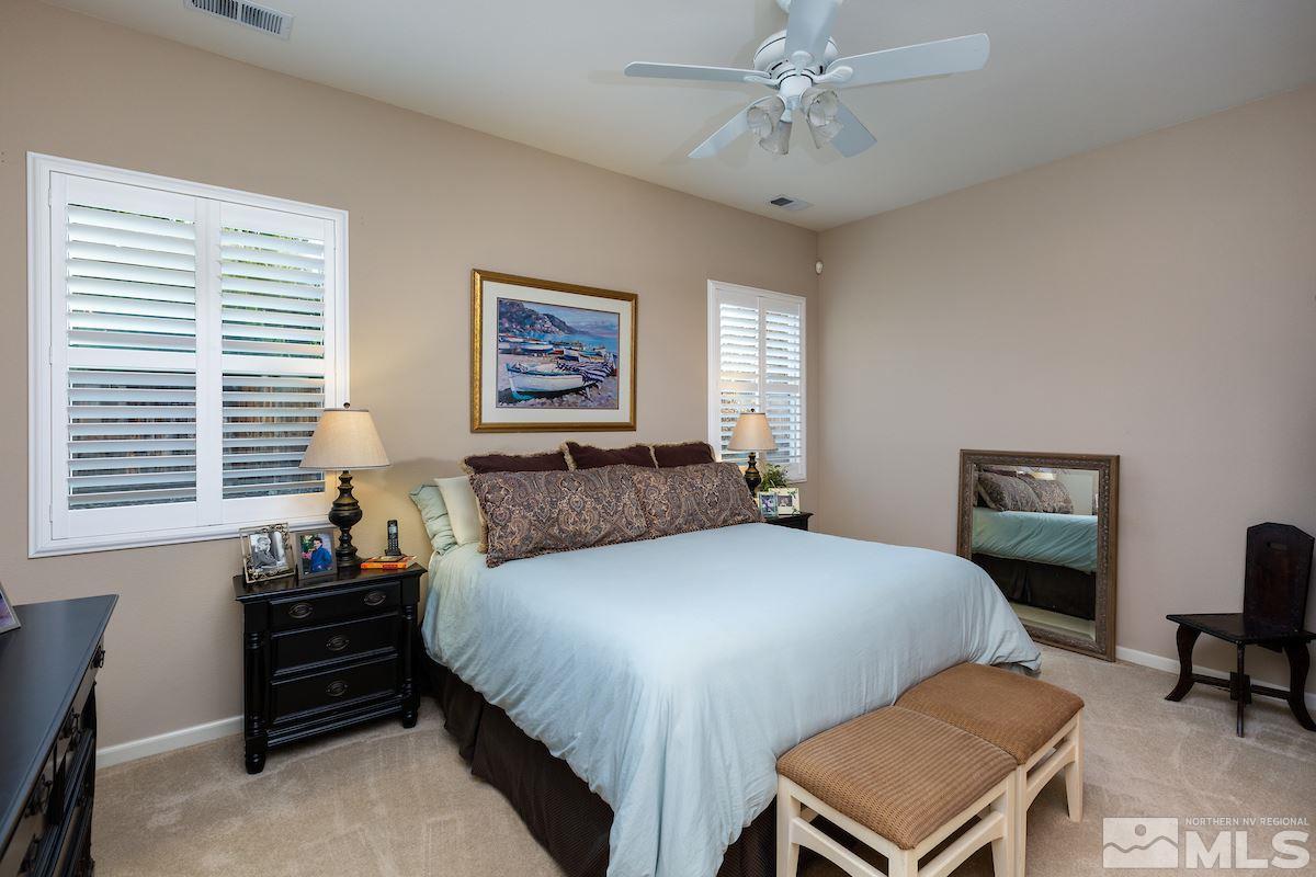 10600 Sterling Ridge Way Reno, NV 89521 - Photo 11 of 25 a bedroom with a bed and a chandelier