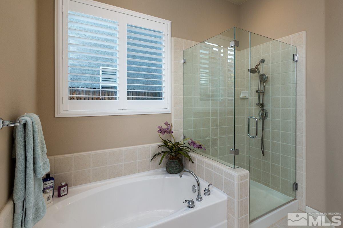 10600 Sterling Ridge Way Reno, NV 89521 - Photo 14 of 25 a bathroom with a bathtub and a shower