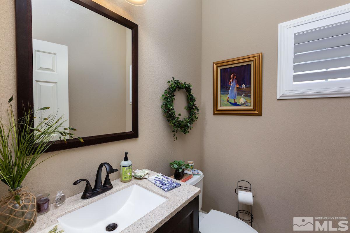 10600 Sterling Ridge Way Reno, NV 89521 - Photo 17 of 25 a bathroom with a sink a mirror and a toilet