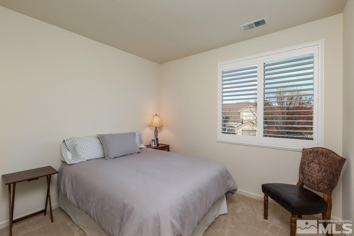 10600 Sterling Ridge Way Reno, NV 89521 - Photo 18 of 25 a bedroom with a bed chair and window