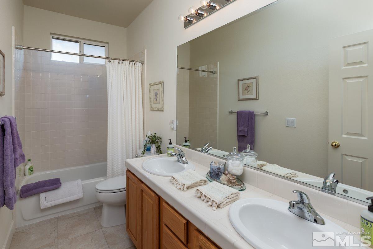 10600 Sterling Ridge Way Reno, NV 89521 - Photo 20 of 25 a bathroom with a granite countertop sink toilet and shower