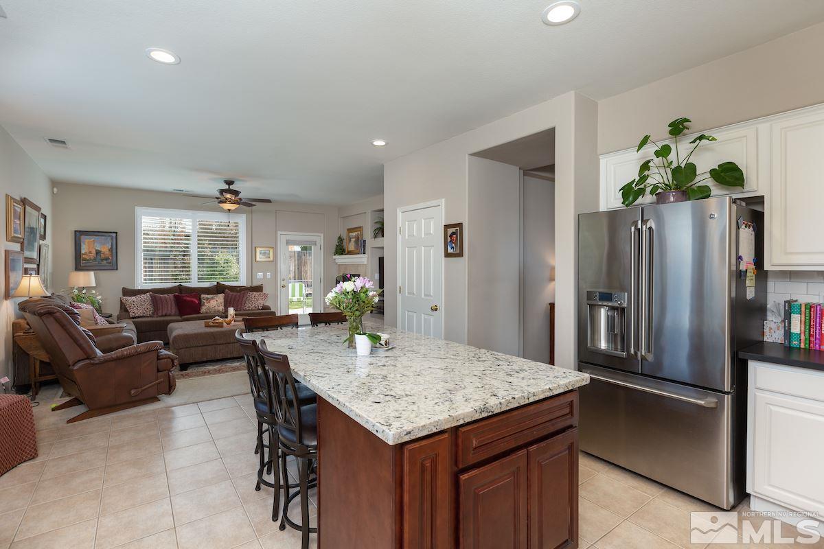 10600 Sterling Ridge Way Reno, NV 89521 - Photo 7 of 25 a living room with kitchen island furniture and a refrigerator