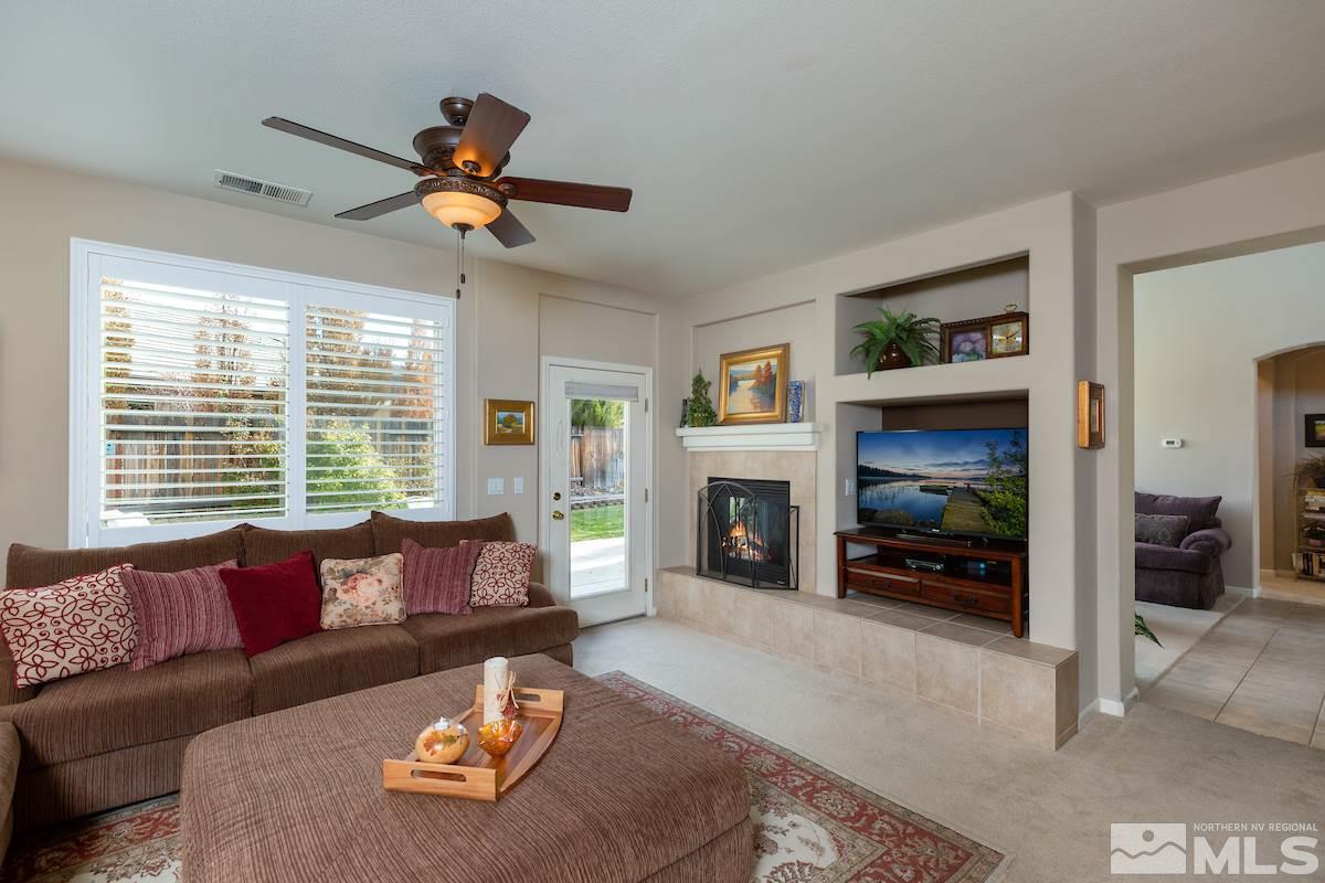 10600 Sterling Ridge Way Reno, NV 89521 - Photo 10 of 25 a living room with furniture large window and a fireplace