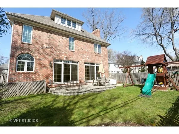 a front view of a house with a yard table and chairs