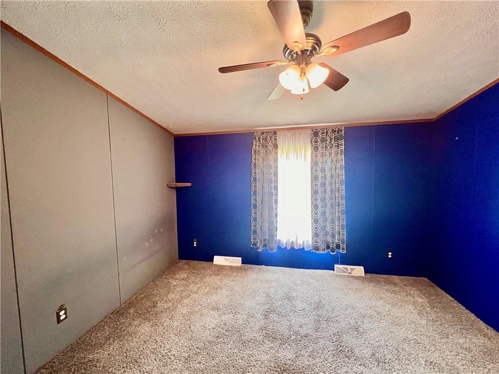 151 Crum Road Bessemer, PA 16112 - Photo 11 of 16 an empty room with windows and fan