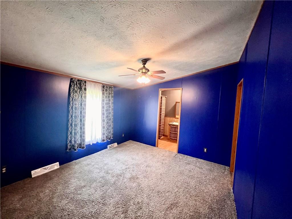151 Crum Road Bessemer, PA 16112 - Photo 10 of 16 a view of a livingroom with a ceiling fan and window