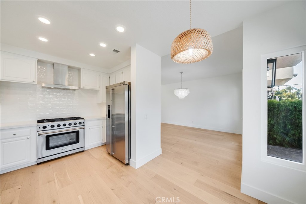 a view of a kitchen with a stove cabinets and wooden floor