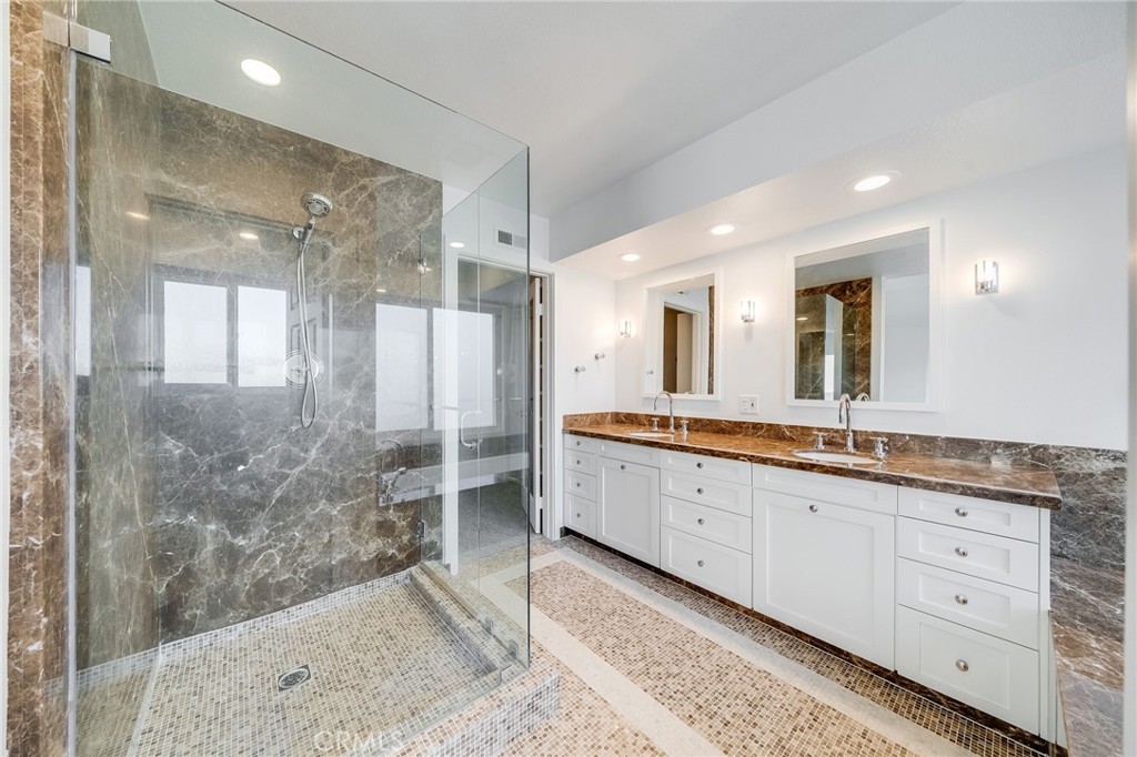 25 St John Dana Point, CA 92629 - Photo 11 of 17 a bathroom with a granite countertop sink mirror and shower