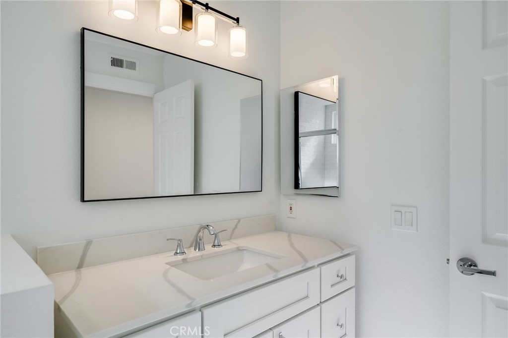 25 St John Dana Point, CA 92629 - Photo 13 of 17 a bathroom with a sink and a mirror