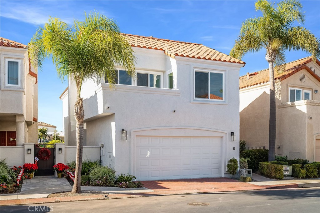 25 St John Dana Point, CA 92629 - Photo 3 of 17 a front view of a house with a yard and garage