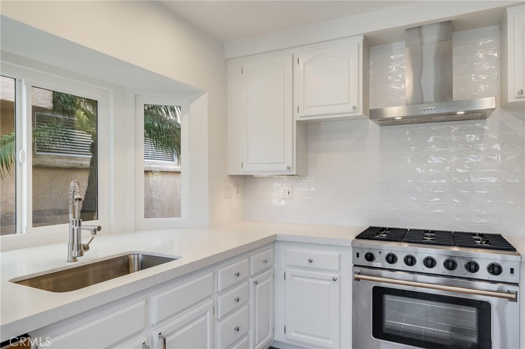 25 St John Dana Point, CA 92629 - Photo 5 of 17 a kitchen with white cabinets and a stove