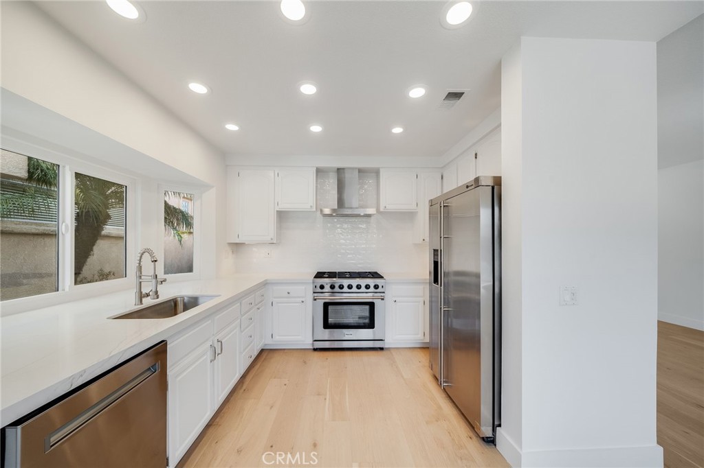 25 St John Dana Point, CA 92629 - Photo 6 of 17 a kitchen with refrigerator cabinets and a sink
