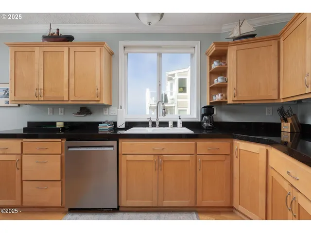 a kitchen with stainless steel appliances granite countertop a sink and cabinets