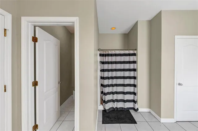 a view of a closet area with wooden floor and cabinet