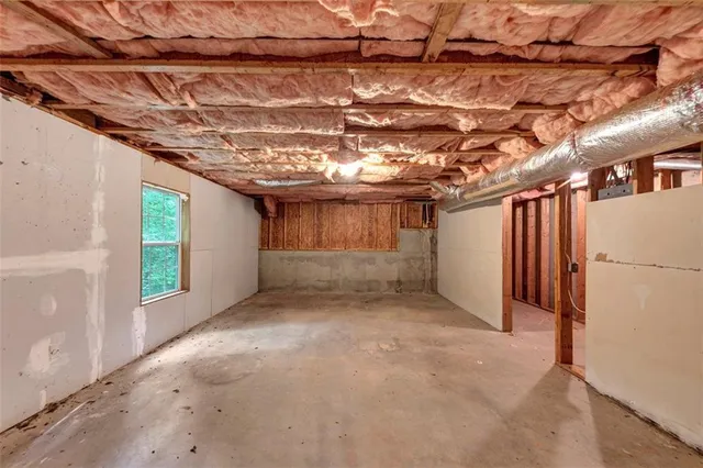 a view of a room with a wooden roof and windows