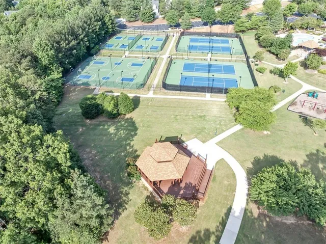 an aerial view of a house with a yard basket ball court