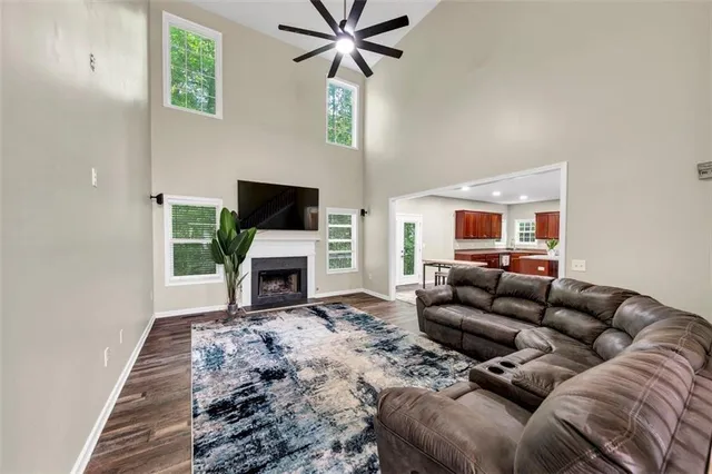 a living room with furniture a fireplace and a flat screen tv