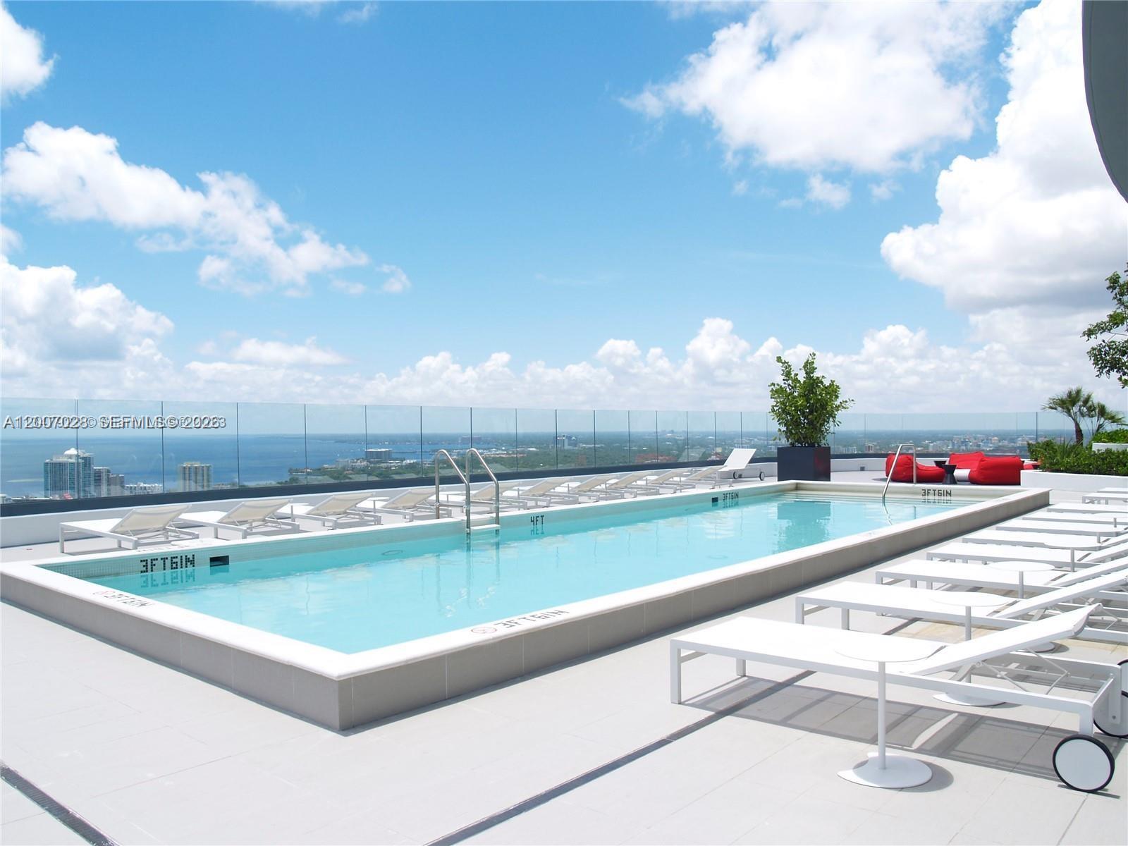 55 Southwest 9th Street, Unit 2502 Miami, FL 33130 - Photo 11 of 27 a view of swimming pool with outdoor seating