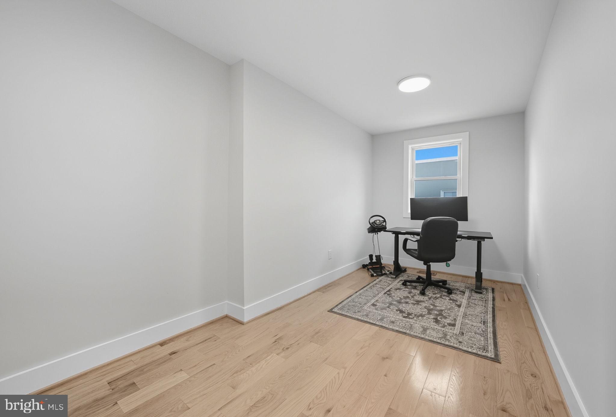 4902 4th Street Northwest Washington, DC 20011 - Photo 15 of 22 a work room with furniture a rug and a window