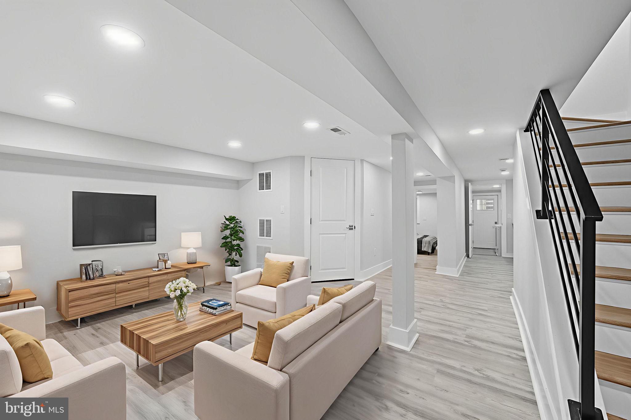 4902 4th Street Northwest Washington, DC 20011 - Photo 16 of 22 a living room with furniture and a flat screen tv