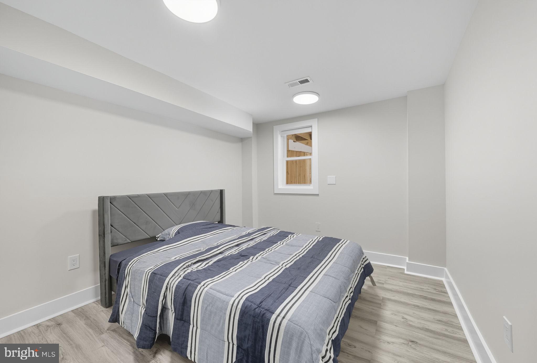 4902 4th Street Northwest Washington, DC 20011 - Photo 19 of 22 a bedroom with a bed and a window