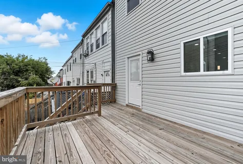 a view of a wooden deck with a yard