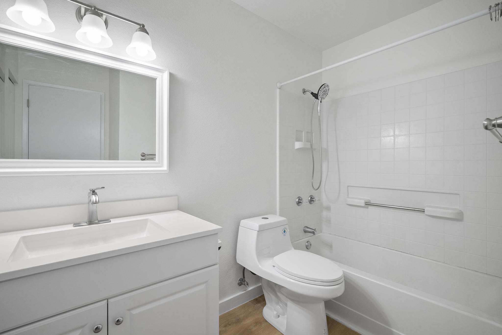 68-3831 Lua Kula Street, Unit E102 Waikoloa, HI 96738 - Photo 11 of 26 a bathroom with a sink a toilet and shower