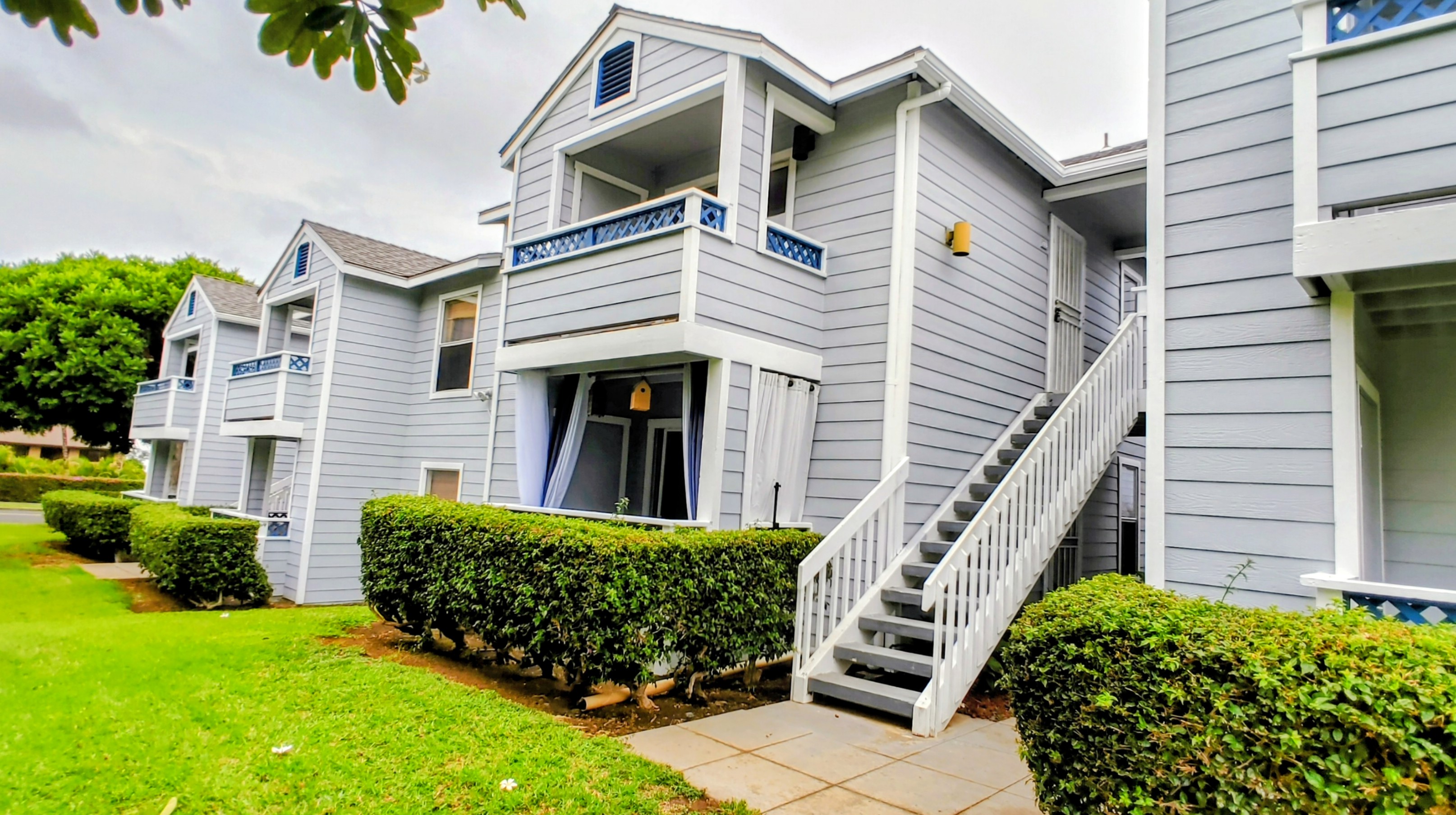 68-3831 Lua Kula Street, Unit E102 Waikoloa, HI 96738 - Photo 14 of 26 a front view of a house with a garden