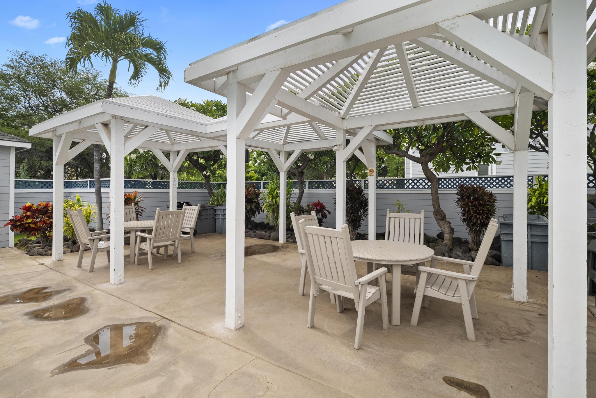 68-3831 Lua Kula Street, Unit E102 Waikoloa, HI 96738 - Photo 19 of 26 a view of a patio with a table and chairs under an umbrella