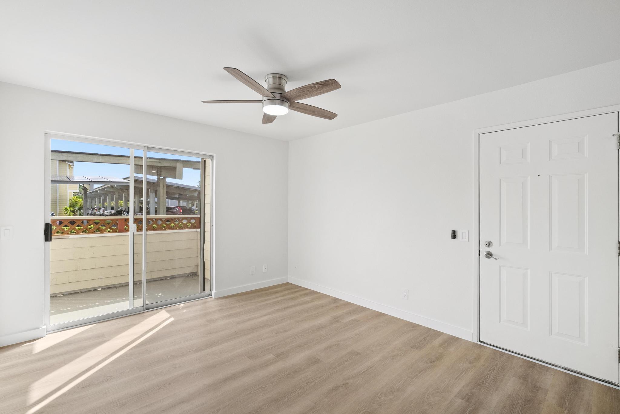 68-3831 Lua Kula Street, Unit E102 Waikoloa, HI 96738 - Photo 6 of 26 a view of empty room with wooden floor and fan