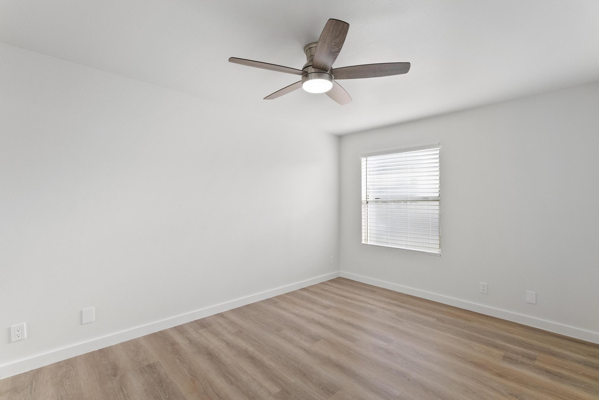 68-3831 Lua Kula Street, Unit E102 Waikoloa, HI 96738 - Photo 10 of 26 wooden floor in an empty room with a window