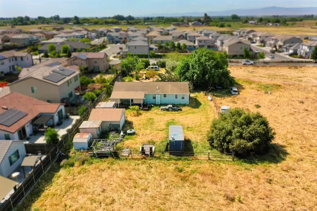 an aerial view of residential houses with outdoor space
