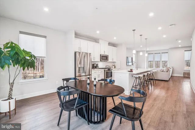a view of a dining room with furniture and wooden floor