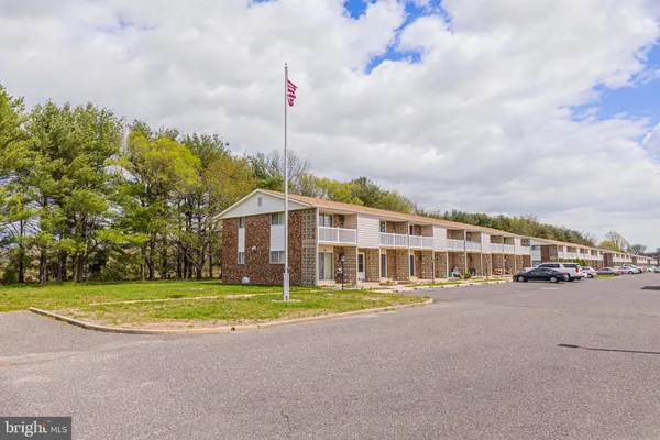 a view of a house with a swimming pool and sitting area