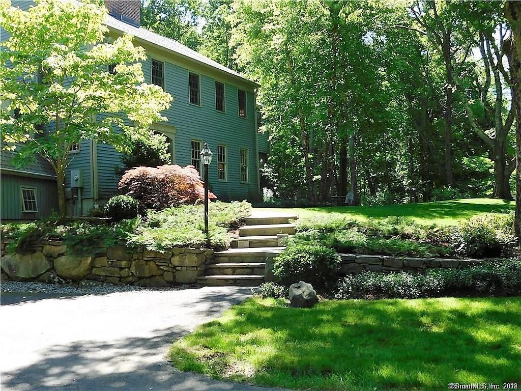 113 Old West Mountain Road Ridgefield, CT 06877 - Photo 1 of 1 a front view of a house with a yard