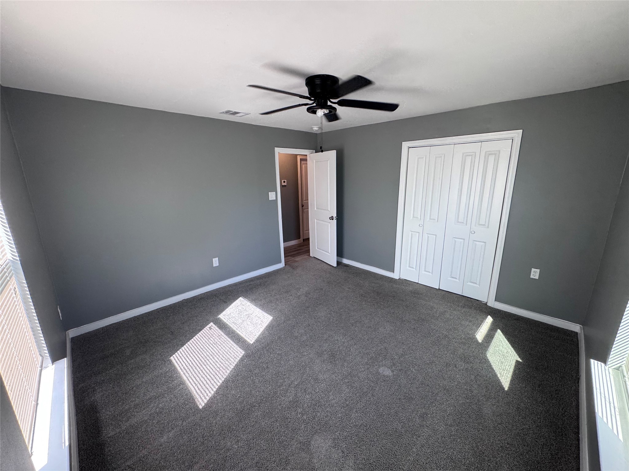 4529 Dewberry Street Houston, TX 77021 - Photo 5 of 10 an empty room with windows and fan