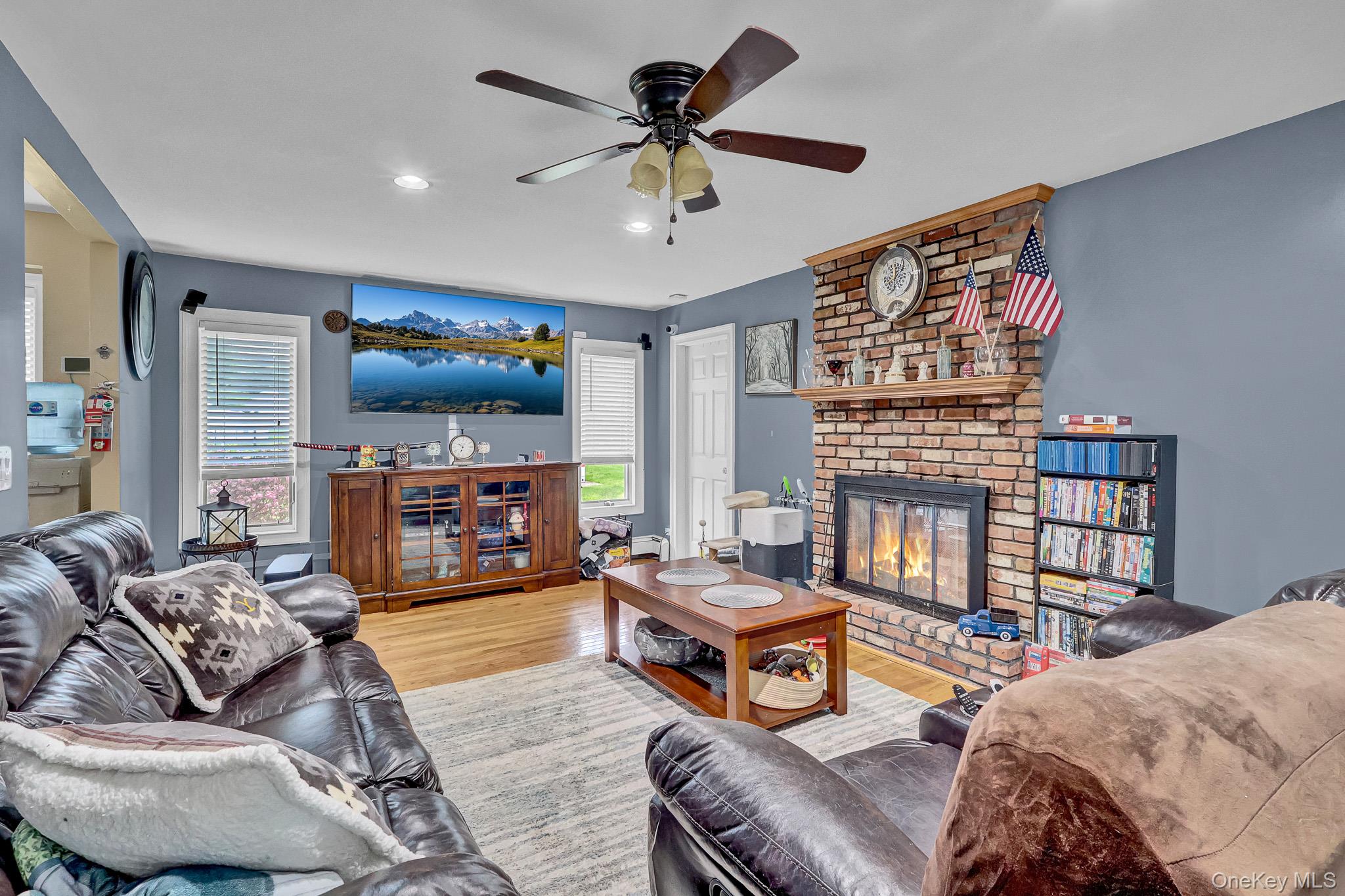 98 Granny Road Farmingville, NY 11738 - Photo 11 of 24 a living room with furniture and a flat screen tv