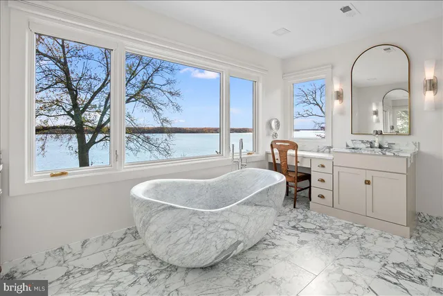 a spacious bathroom with a tub and a large window