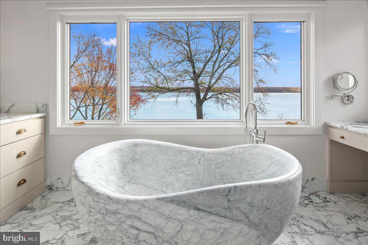 3903 Belle Rive Terrace Alexandria, VA 22309 - Photo 15 of 34 a white bath tub sitting in a bathroom next to a window