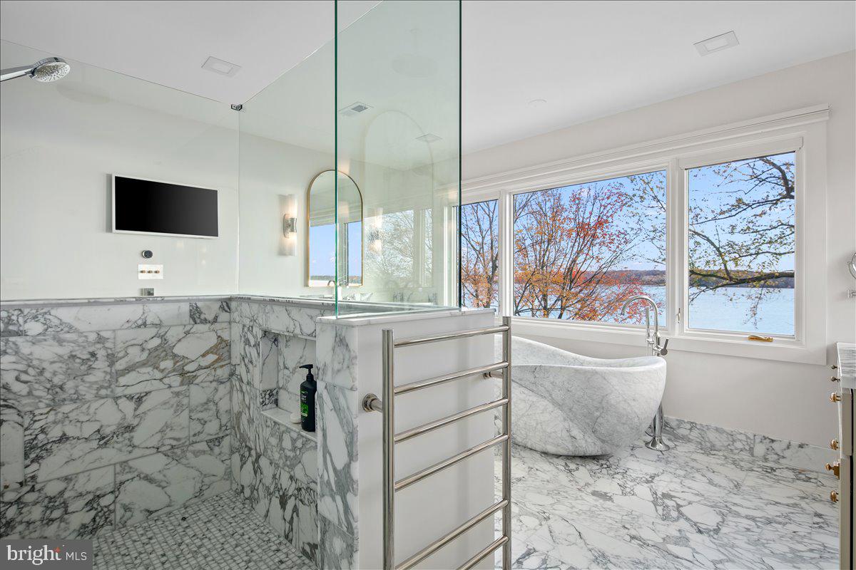 3903 Belle Rive Terrace Alexandria, VA 22309 - Photo 16 of 34 a bathroom with a bathtub sink and mirror