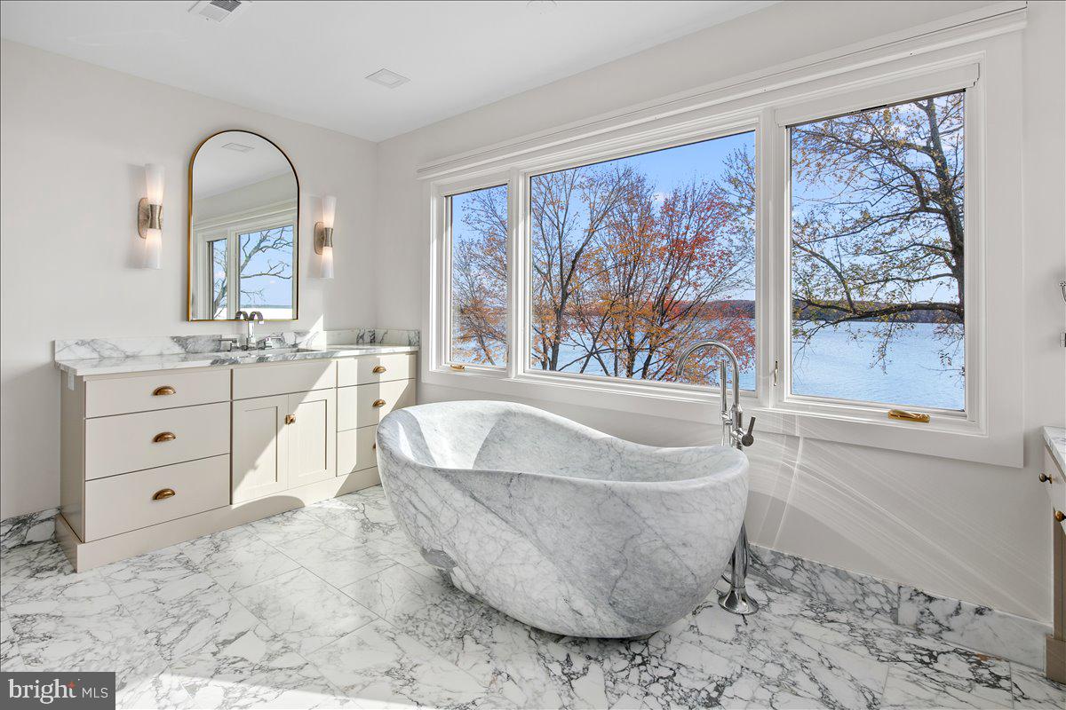 3903 Belle Rive Terrace Alexandria, VA 22309 - Photo 22 of 69 a spacious bathroom with a tub and a large window