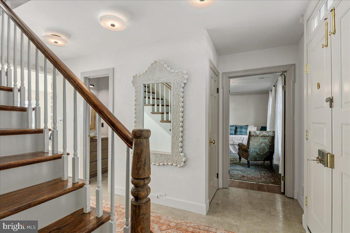 3903 Belle Rive Terrace Alexandria, VA 22309 - Photo 27 of 69 a view of a hallway with wooden floor and stairs