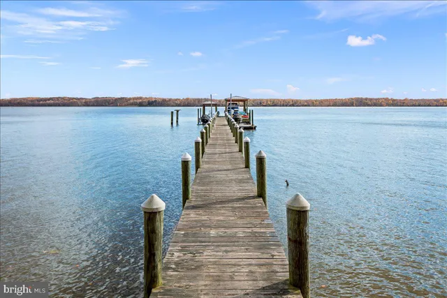 a patio with glass top table and chairs