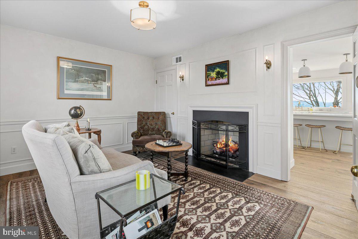 3903 Belle Rive Terrace Alexandria, VA 22309 - Photo 31 of 69 a living room with furniture a flat screen tv and a fireplace