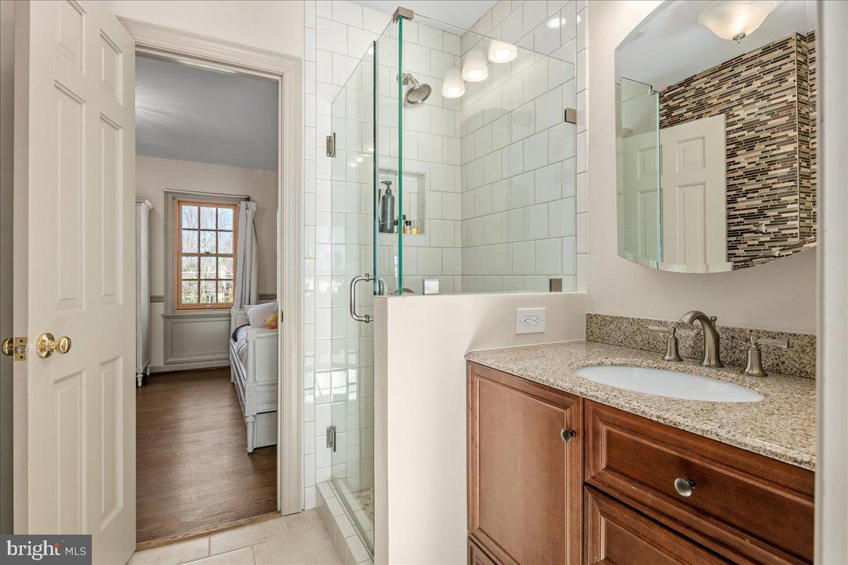 3903 Belle Rive Terrace Alexandria, VA 22309 - Photo 33 of 69 a en suite bathroom with a sink a mirror and a shower