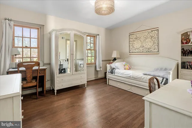 a bathroom with a granite countertop sink and a window