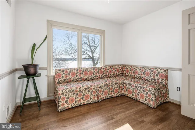 a bathroom with a toilet and a mirror
