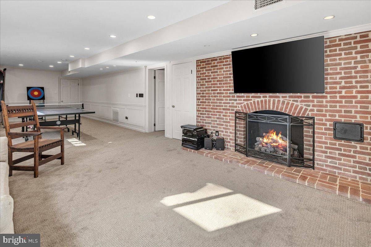 3903 Belle Rive Terrace Alexandria, VA 22309 - Photo 37 of 69 a living room with furniture a flat screen tv and a fireplace