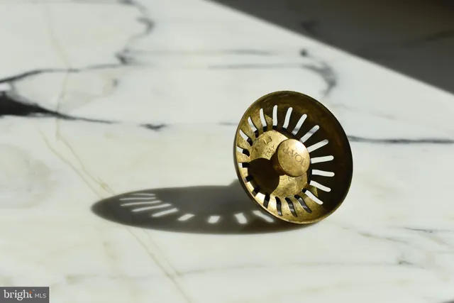 a view of a big house with a big yard and large trees